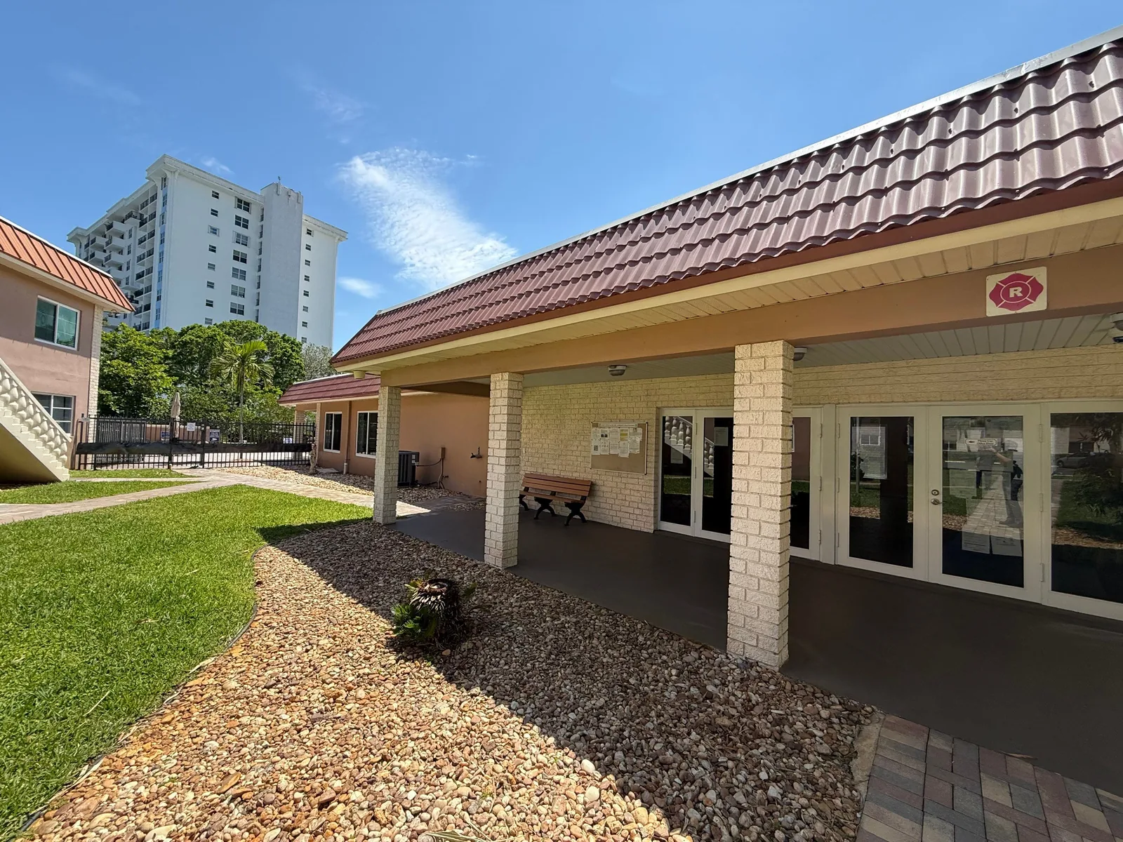 Commercial Painting in Fort Lauderdale, Florida. Community building exterior with painted block walls and columns under a covered walkway.