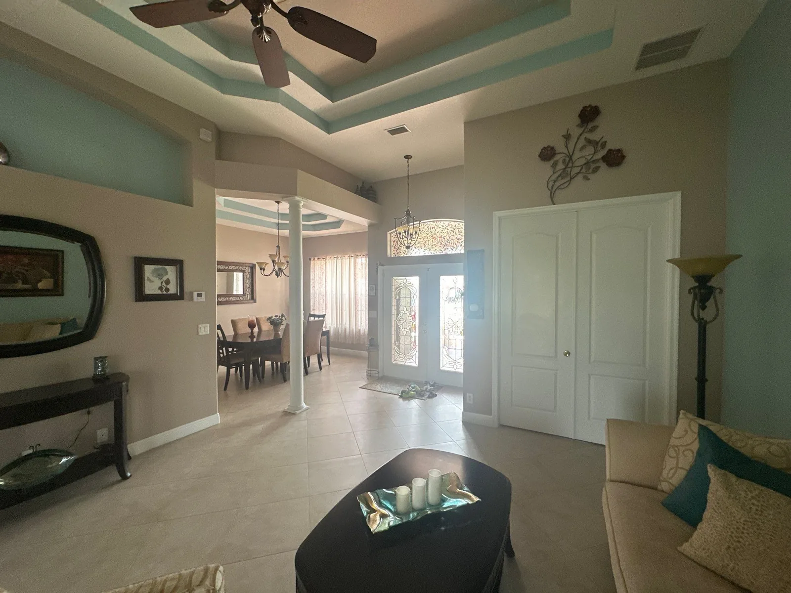 Interior Painting in Port Saint Lucie, Florida. Foyer and entry with a teal-accented tray ceiling, taupe walls and white double doors.